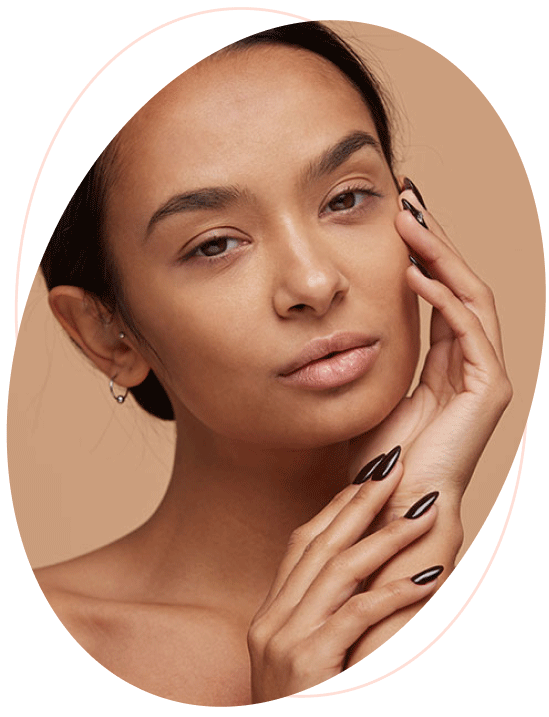 London based dermatologist - services - mixed race young woman touching her face