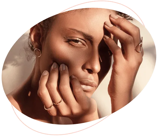 Dermatologist prices - image at the top of the page of a mixed race woman touching her face