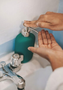 London based dermatologist - In the press - Closeup of a person's hands squeezing soap from the soap dispenser