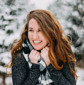 A woman smiling while standing outside in winter