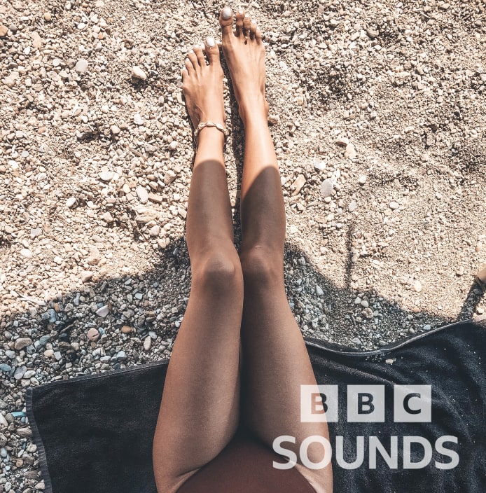 Legs of a woman at a beach sunbathing