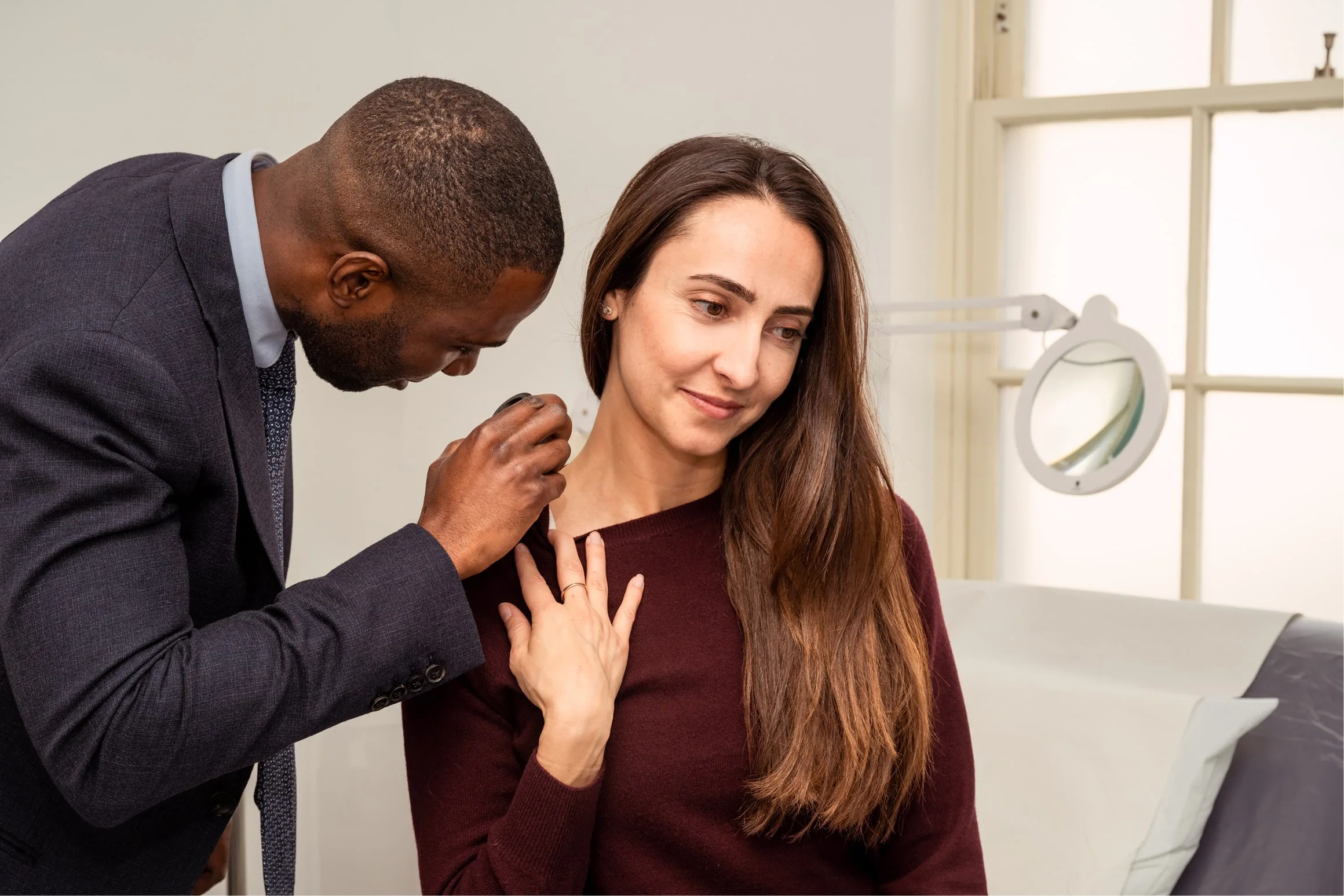 Dr Derrick checking a patients skin