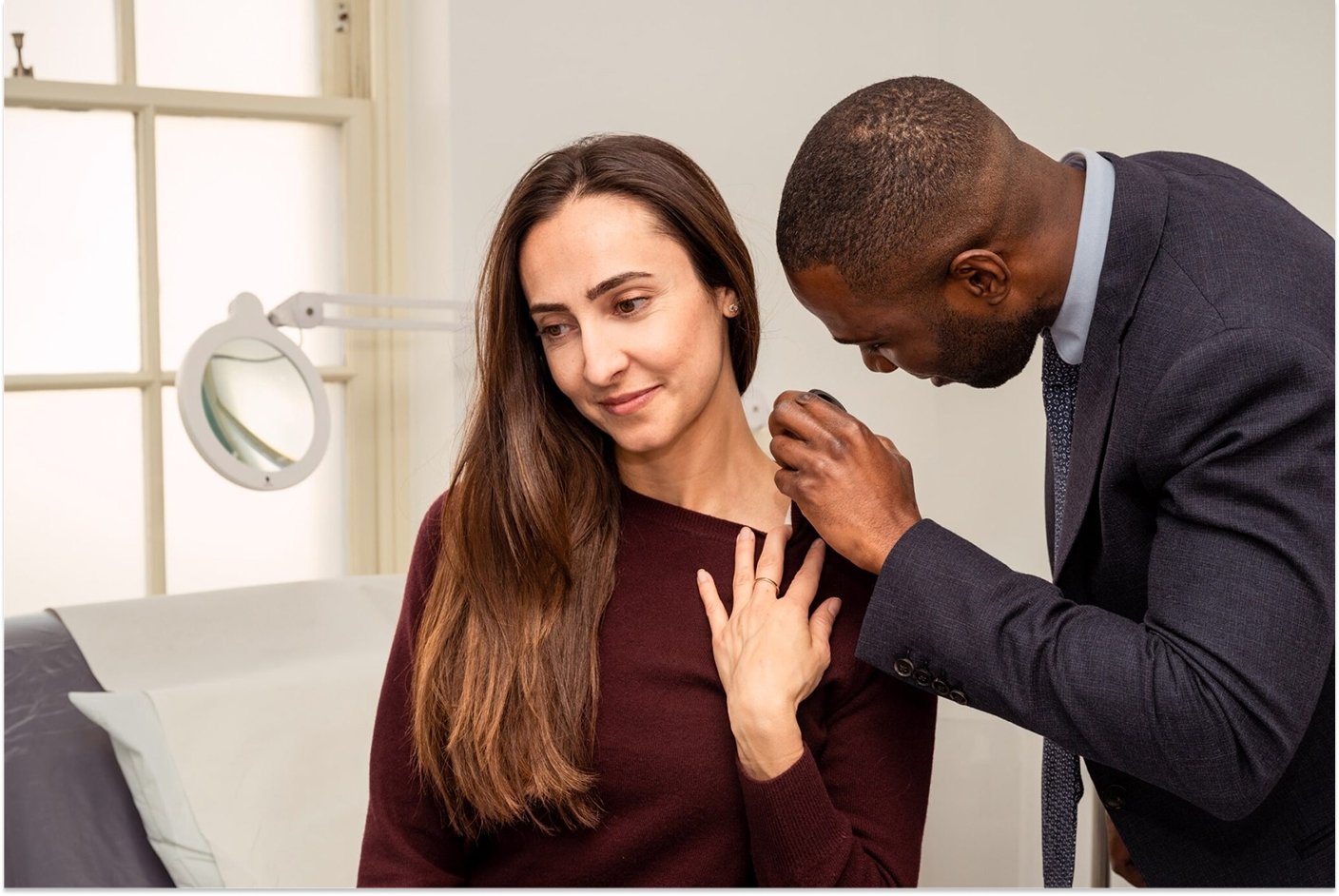 derrick inspecting patients skin